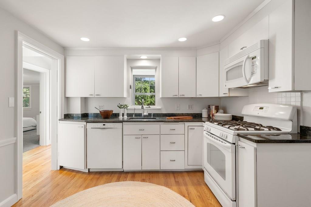 20 Oakmont Road Newton, MA 02459 - Photo 11 of 33 a kitchen with stainless steel appliances granite countertop a stove a sink and a white cabinets