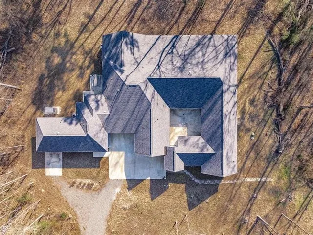 a view of a house with a yard chairs and wooden fence