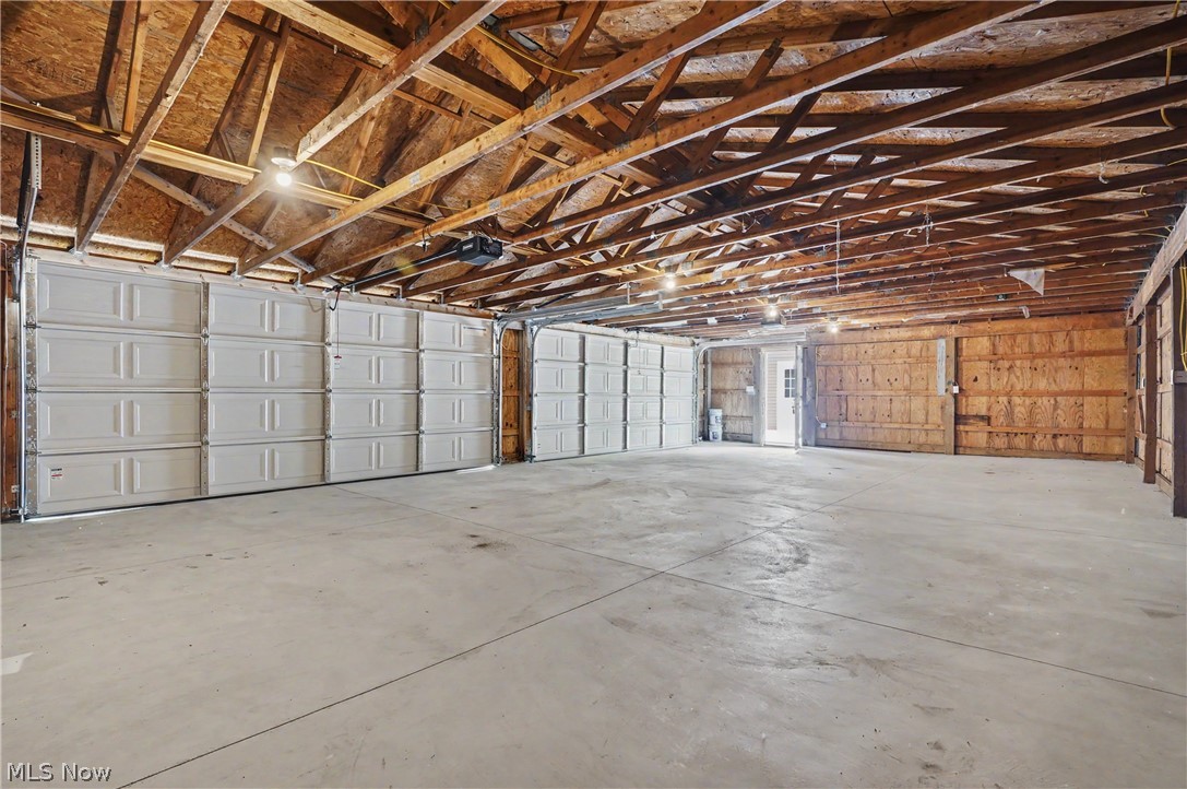 7583 Yale Road Atwater, OH 44201 - Photo 8 of 41 4 car garage was completely updated in 2026. Garage features extra storage space, electric, interior/exterior lighting, door openers, garage doors, man door, concrete foundation, outlets, roof, gutters and downspouts.
