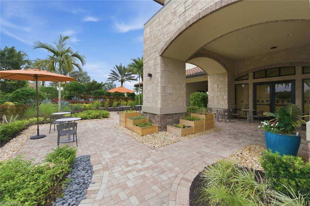 9365 Pocida Court, Unit 202 Naples, FL 34119 - Photo 38 of 40 a view of a swimming pool with a patio