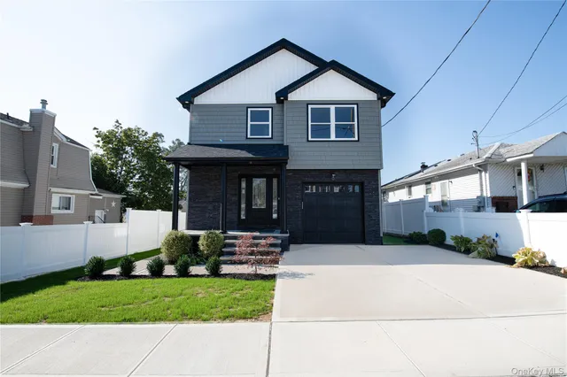 a front view of a house with a yard and porch