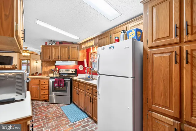 a kitchen with a sink cabinets and window