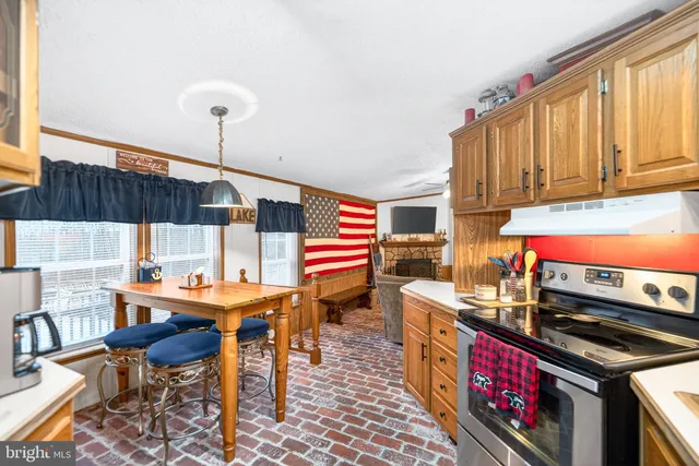 a kitchen with a refrigerator a stove top oven a washer and dryer