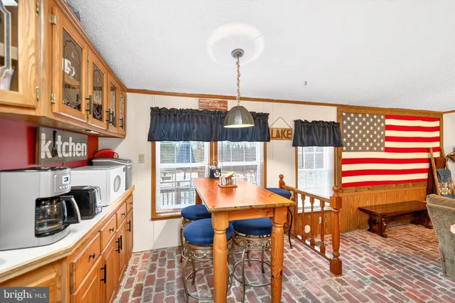 a view of a dining room with furniture and a chandelier