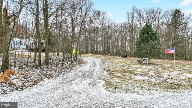 a view of a house with a yard chairs and a table