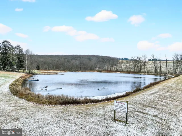 a kitchen that has a lot of cabinets in it and wooden floors