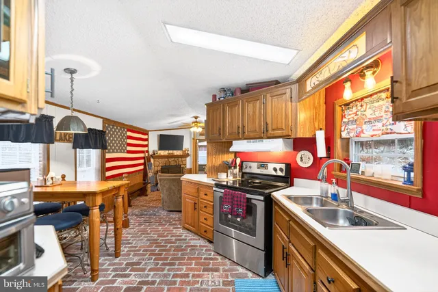 a kitchen with a sink stove and refrigerator