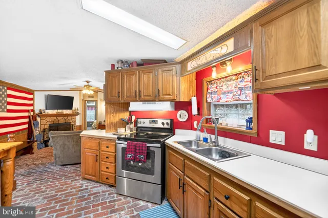 a white refrigerator freezer and a stove sitting inside of a kitchen
