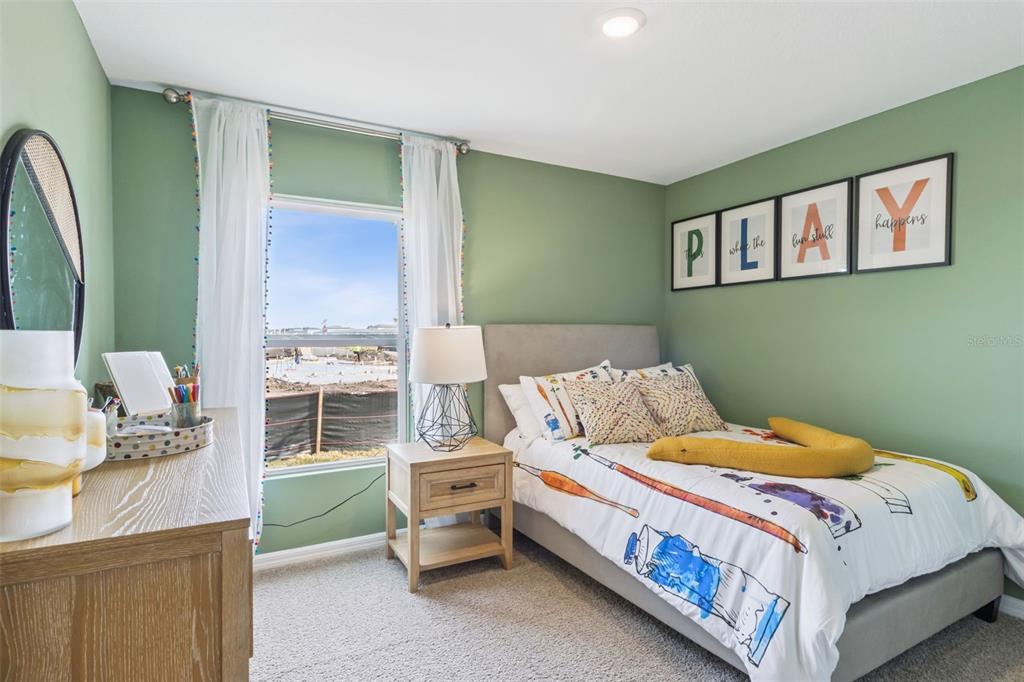 3437 Nettle Loop Tavares, FL 32778 - Photo 27 of 31 a bed room with a bed and a chair