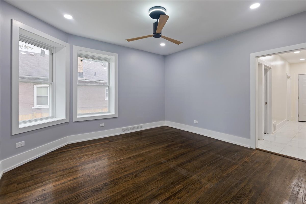 4626 West Monroe Street Chicago, IL 60644 - Photo 13 of 34 a view of an empty room with wooden floor and a window