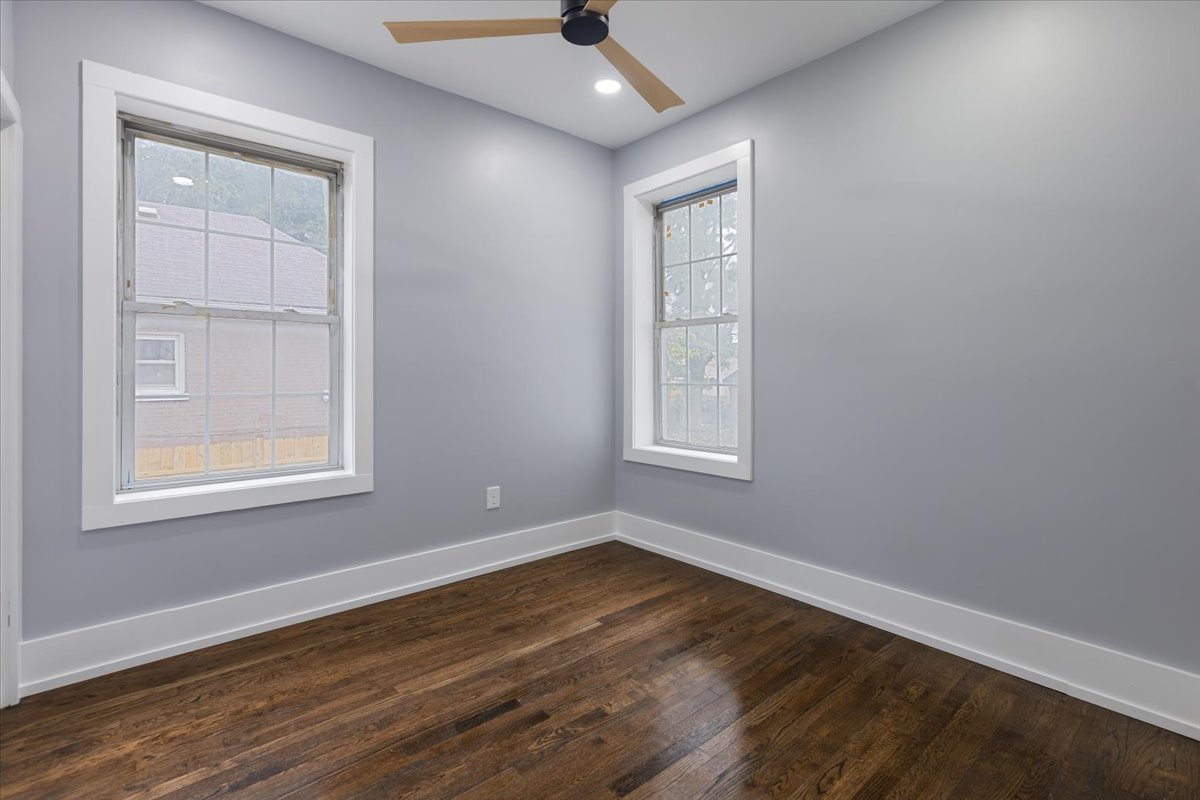 4626 West Monroe Street Chicago, IL 60644 - Photo 18 of 34 an empty room with wooden floor cabinet and windows