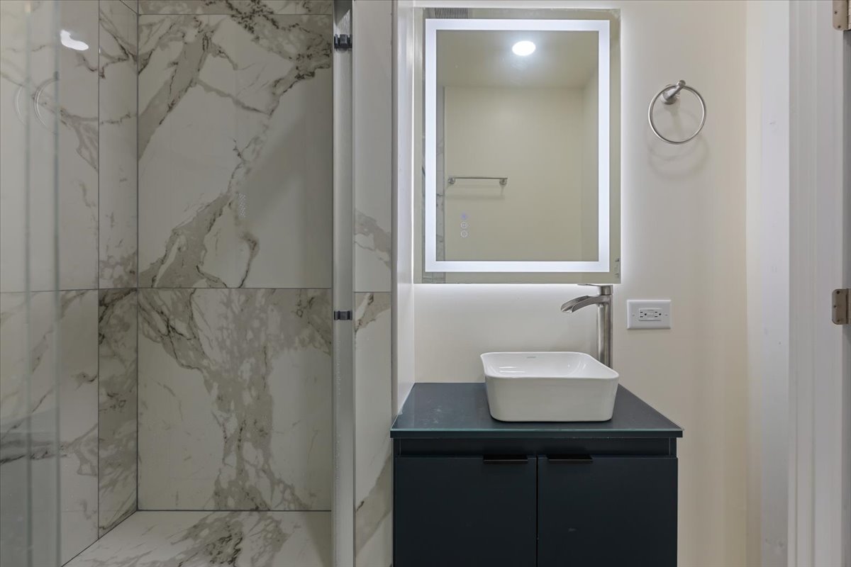 4626 West Monroe Street Chicago, IL 60644 - Photo 21 of 34 a bathroom with a sink a toilet and shower