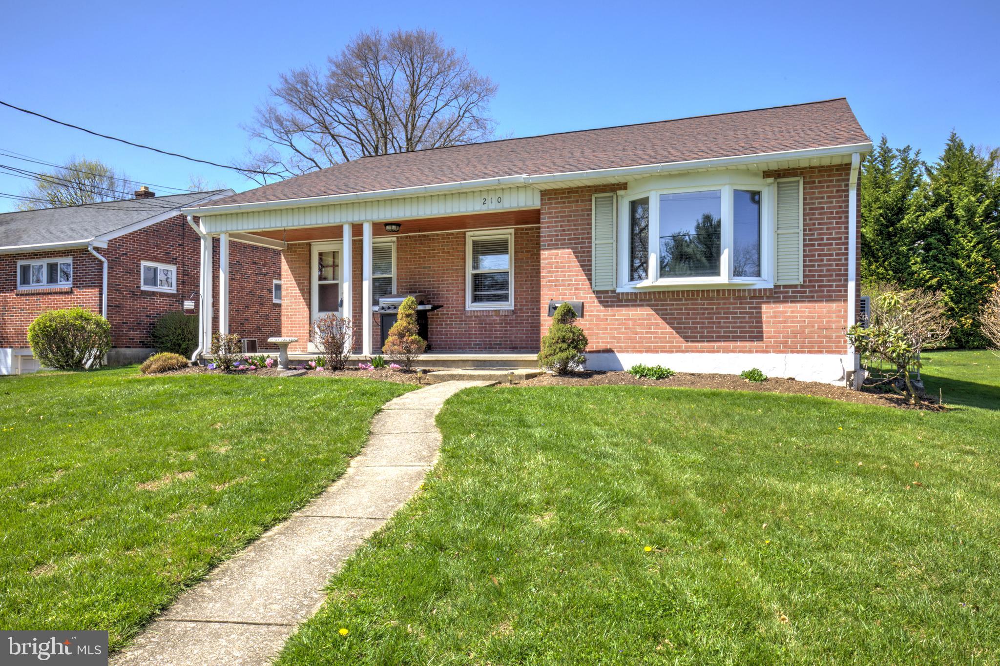 210 South 8th Street Akron, PA 17501 - Photo 2 of 31 a front view of a house with a yard and porch