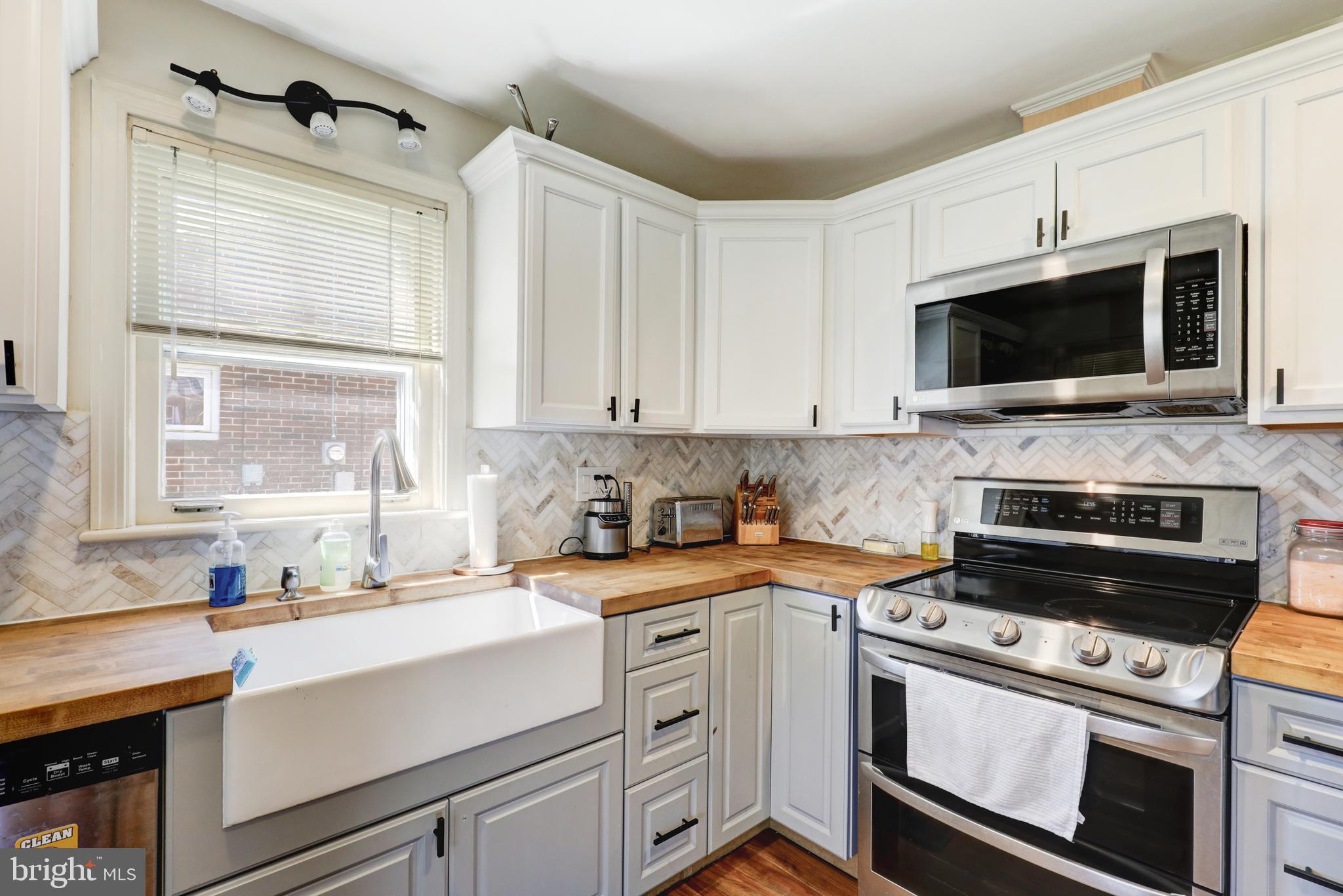 210 South 8th Street Akron, PA 17501 - Photo 9 of 31 a kitchen with a sink stove and microwave