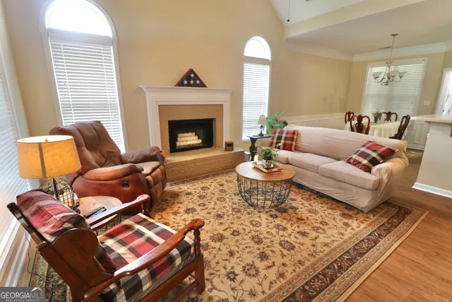 a living room with furniture kitchen view and a fireplace