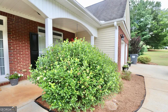 a living room with furniture a fireplace and a chandelier