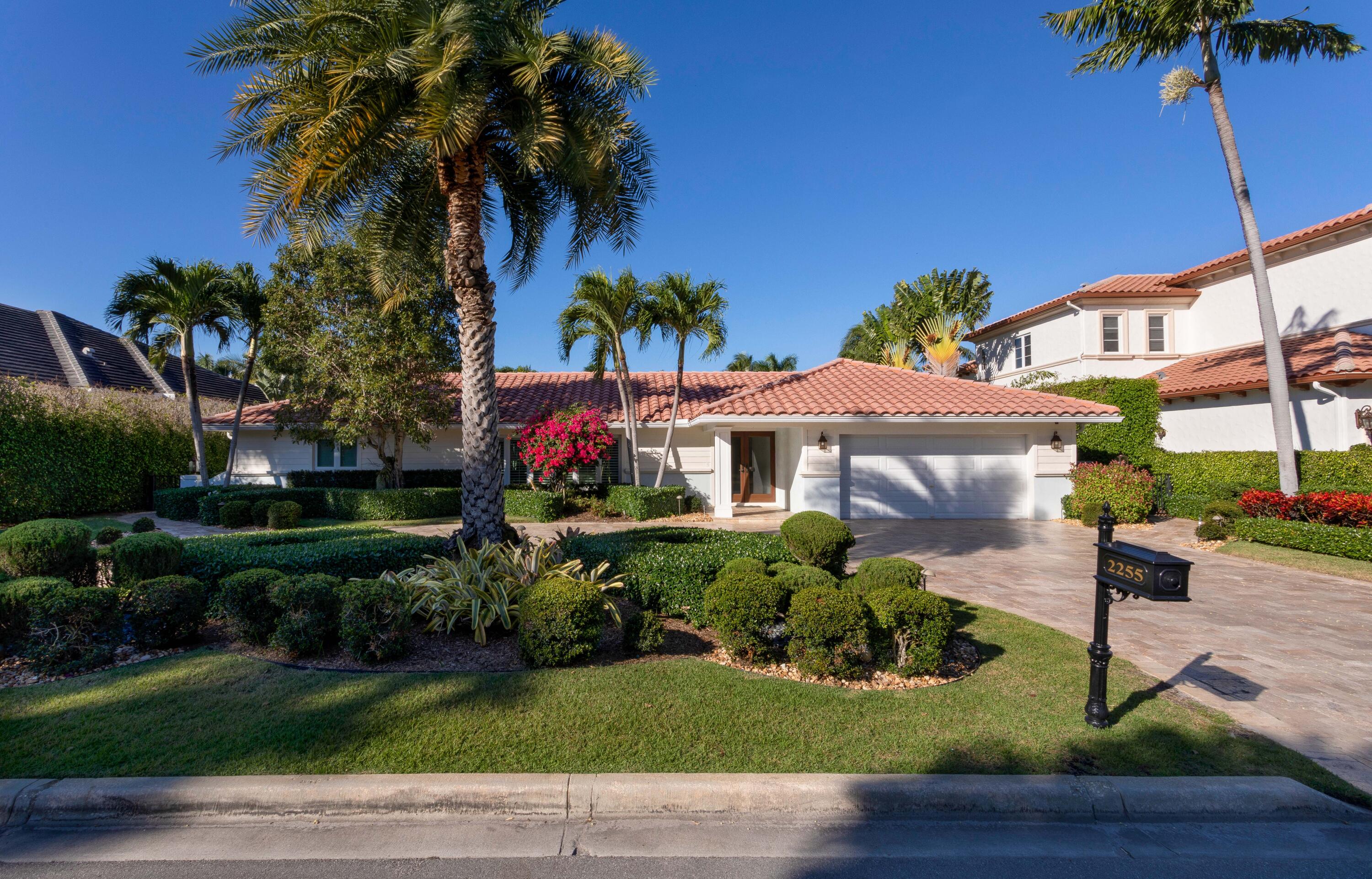 2255 Date Palm Road Boca Raton, FL 33432 - Photo 2 of 14 a front view of a house with a garden