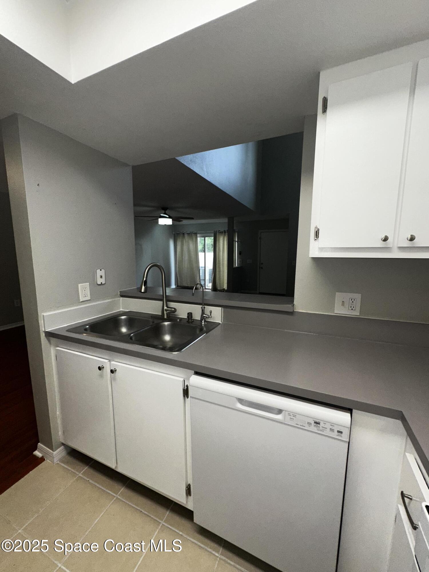 723 Players Court Melbourne, FL 32940 - Photo 7 of 15 a kitchen with stainless steel appliances a sink and cabinets