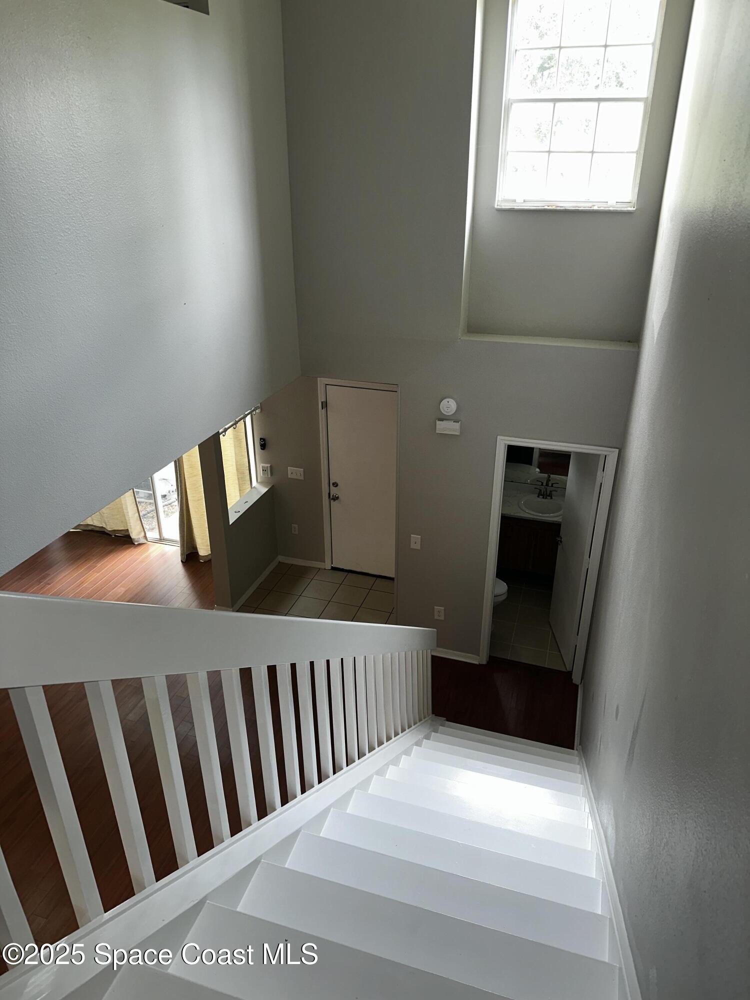 723 Players Court Melbourne, FL 32940 - Photo 9 of 15 a bedroom with a bed and wooden floor