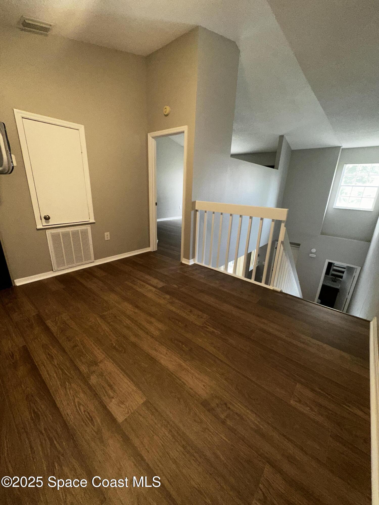 723 Players Court Melbourne, FL 32940 - Photo 10 of 15 a view of an empty room and wooden floor