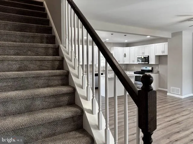 a view of a hallway with closet and a black door
