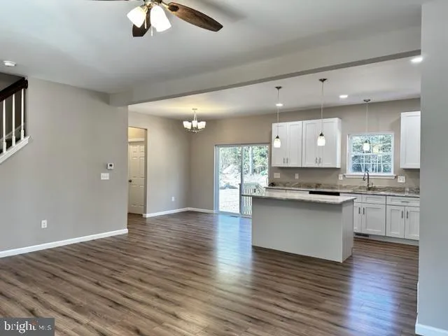 a kitchen with stainless steel appliances granite countertop a stove top oven and sink