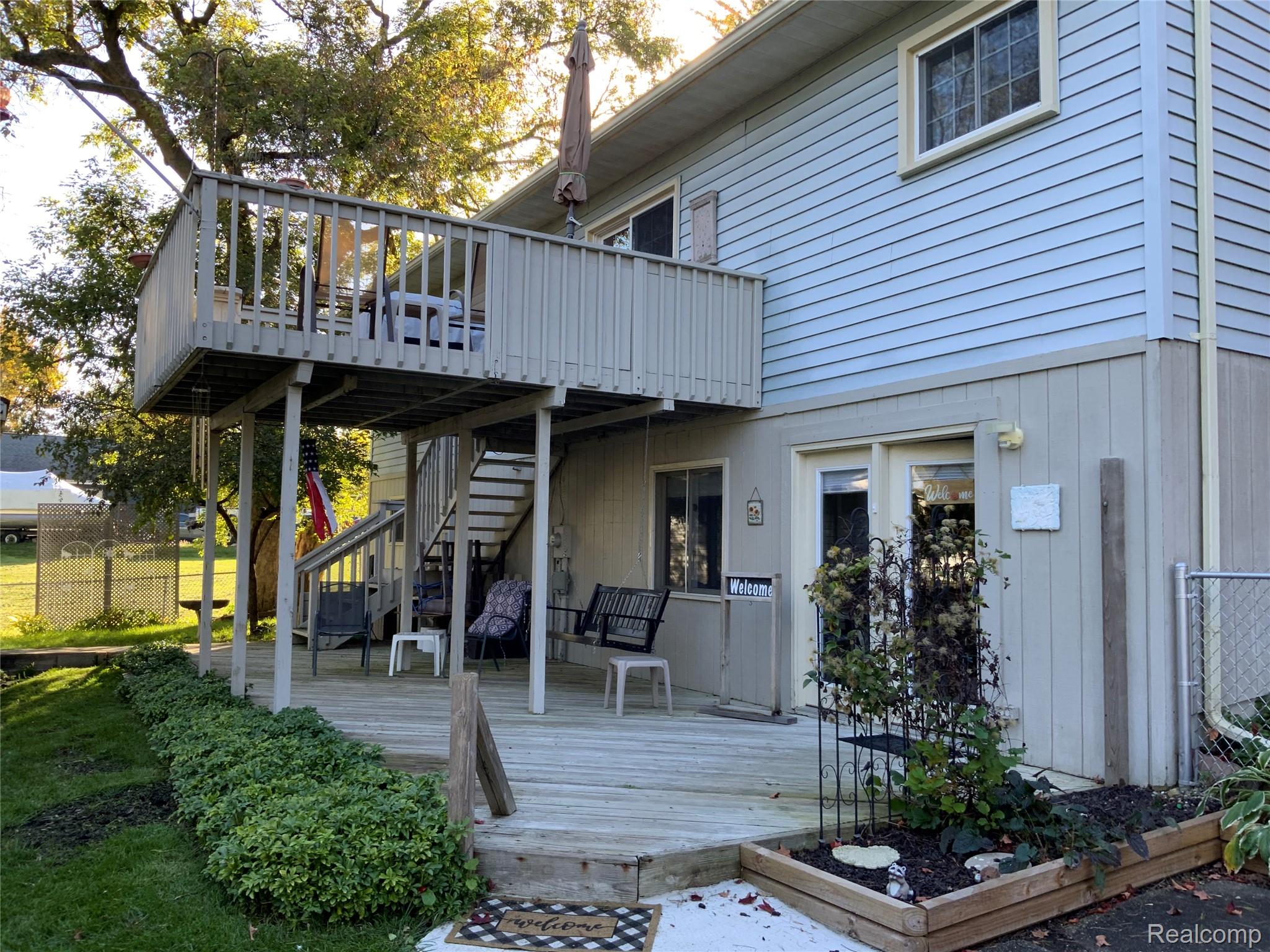 3828 Morgan Road Lake Orion, MI 48359 - Photo 3 of 39 Multi-level deck with wood railing, offering outdoor living space