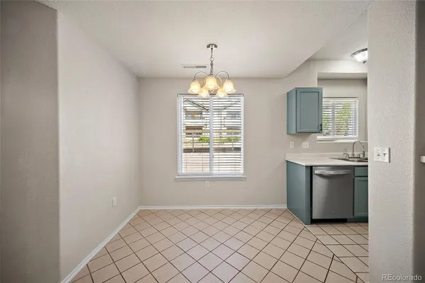 a kitchen with stainless steel appliances granite countertop a sink stove refrigerator and microwave
