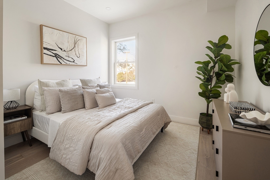 140 Shirley Street, Unit 204 Winthrop, MA 02152 - Photo 12 of 21 a bedroom with bed and a potted plant