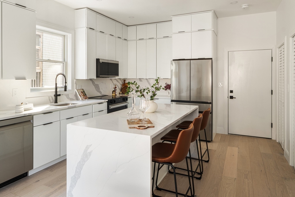 140 Shirley Street, Unit 204 Winthrop, MA 02152 - Photo 3 of 21 a kitchen with a table and chairs in it