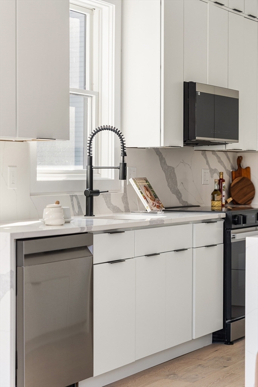 140 Shirley Street, Unit 204 Winthrop, MA 02152 - Photo 4 of 21 a kitchen with a sink and a stove top oven