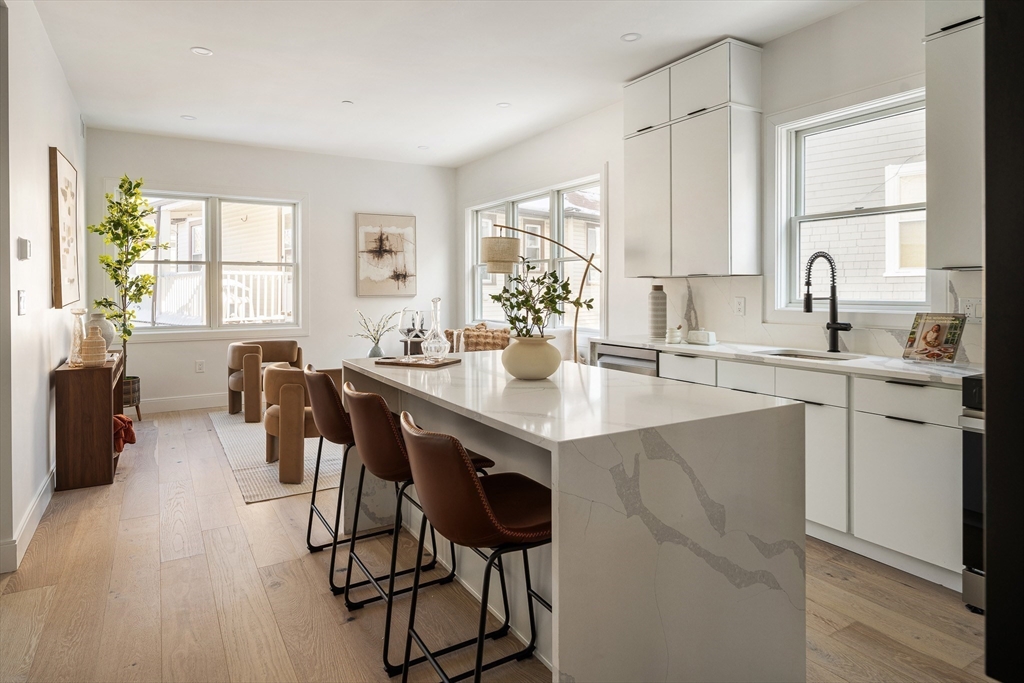140 Shirley Street, Unit 204 Winthrop, MA 02152 - Photo 5 of 21 a kitchen with a table chairs sink and cabinets
