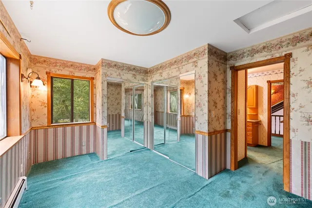 a bathroom with a granite countertop sink and a large mirror next to a window