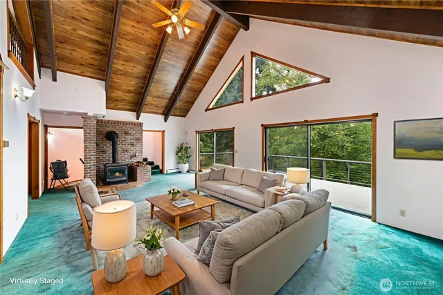 a view of an empty room with windows and fireplace