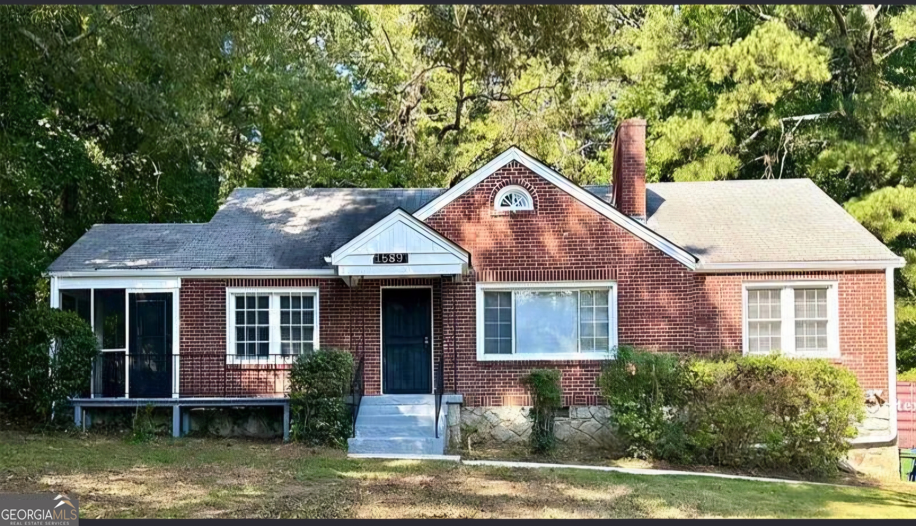 1589 Pinehurst Drive Southwest Atlanta, GA 30311 - Photo 1 of 10 a front view of a house with a yard