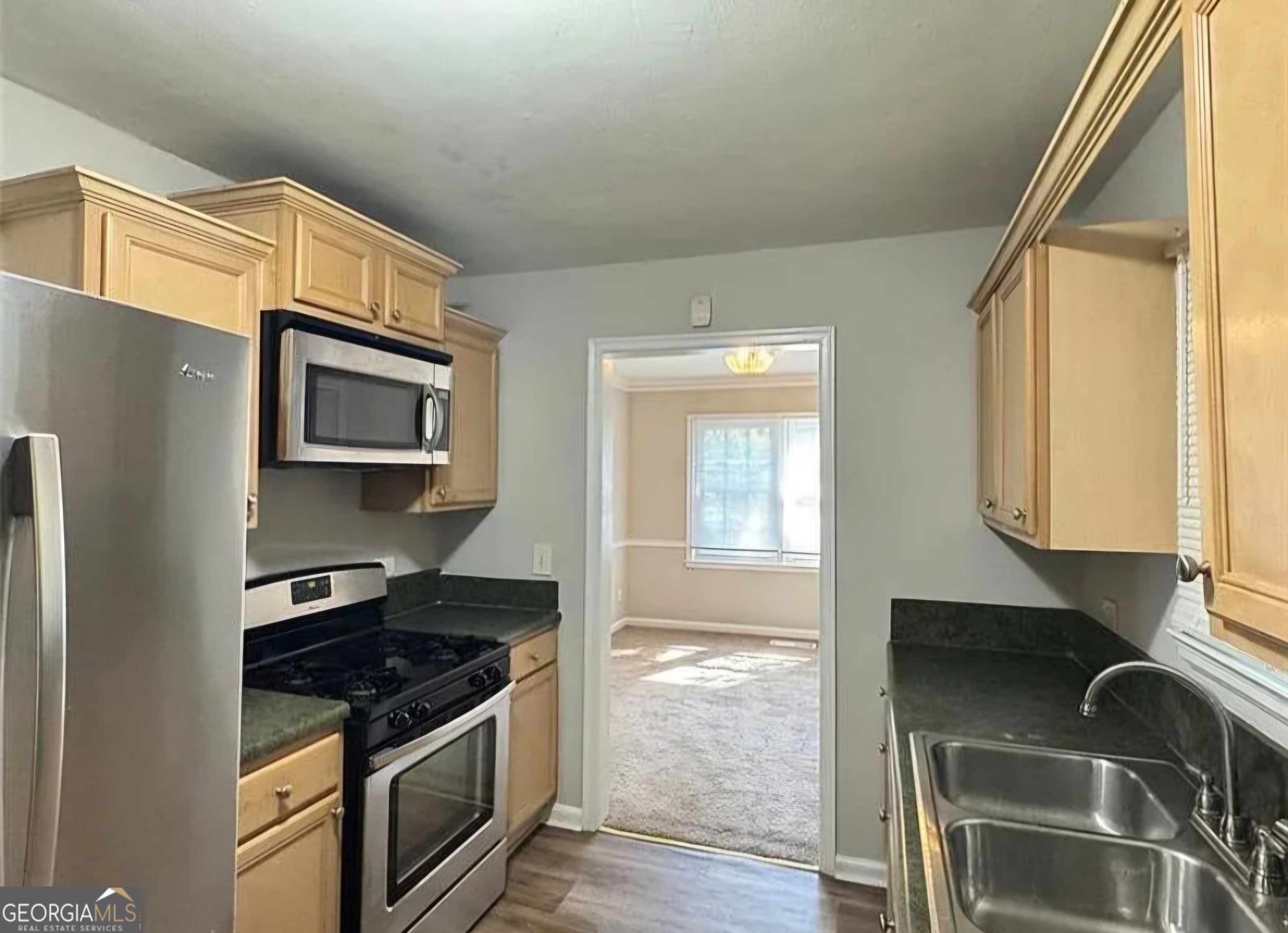 1589 Pinehurst Drive Southwest Atlanta, GA 30311 - Photo 5 of 10 a kitchen with stainless steel appliances granite countertop a stove and a microwave