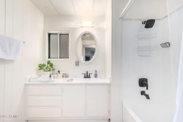 a bathroom with a sink vanity and mirror