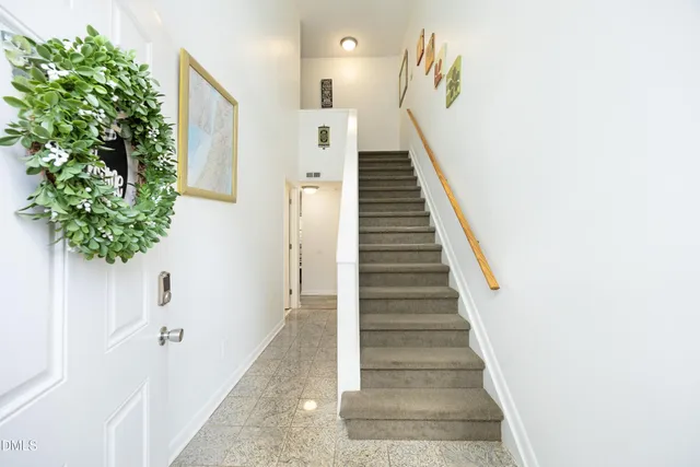 a view of entryway and hall with wooden floor