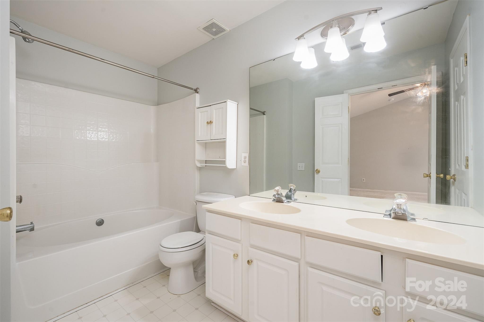 6604 Rothchild Drive Charlotte, NC 28270 - Photo 16 of 32 a bathroom with a double vanity sink toilet mirror and shower