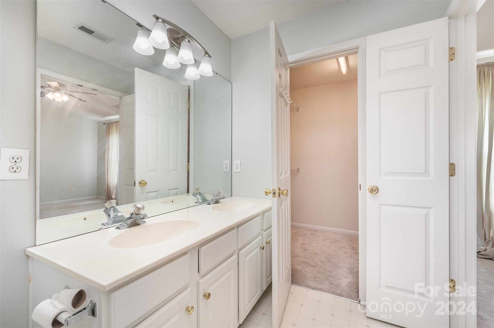 6604 Rothchild Drive Charlotte, NC 28270 - Photo 17 of 32 a bathroom with a sink vanity and a mirror