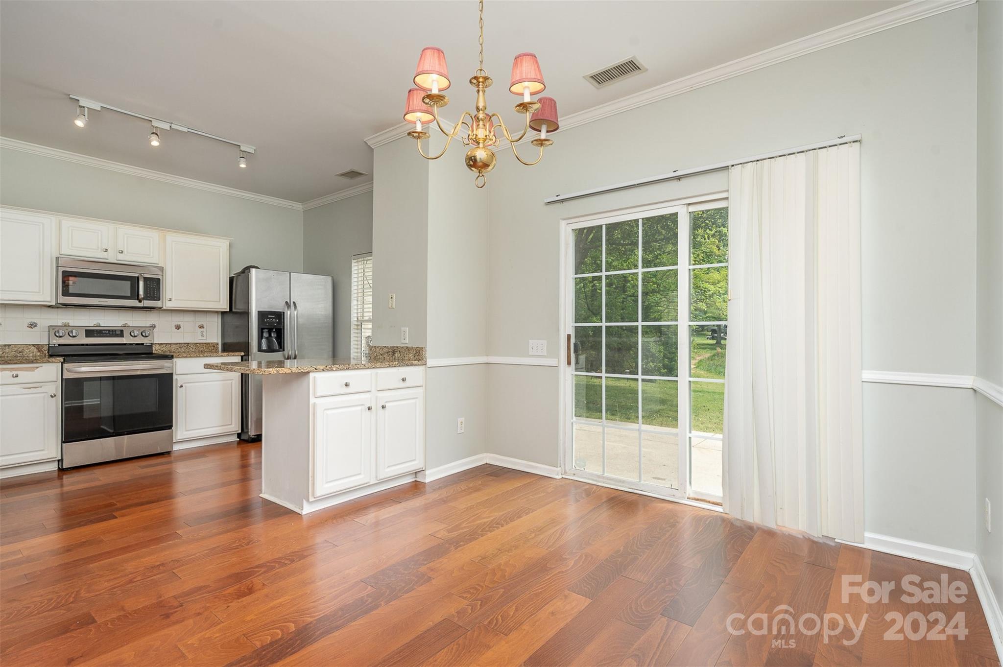 6604 Rothchild Drive Charlotte, NC 28270 - Photo 4 of 32 a view of a kitchen with microwave and stove top oven