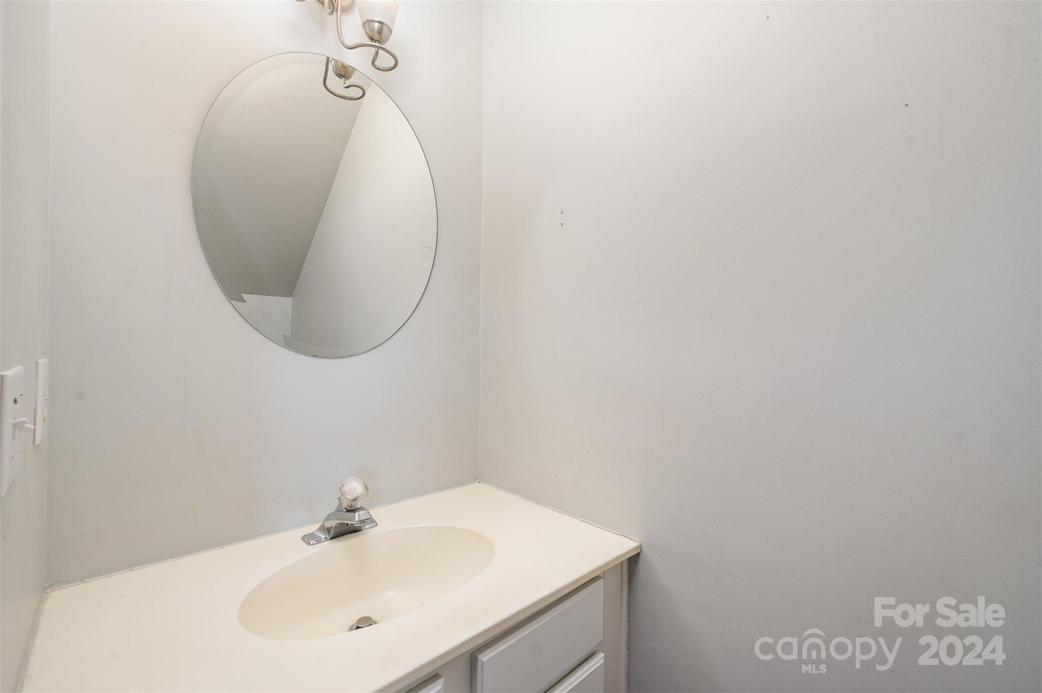 6604 Rothchild Drive Charlotte, NC 28270 - Photo 8 of 32 a bathroom with a sink and a mirror