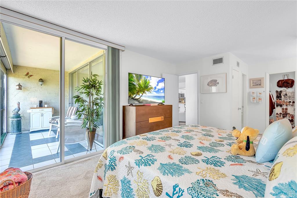 12200 Vonn Road, Unit 2206 Largo, FL 33774 - Photo 27 of 60 a bedroom that has a bed and a large window