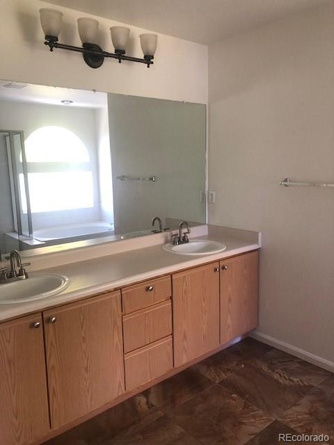 Undisclosed Address Commerce City, CO 80022 - Photo 12 of 12 a bathroom with a sink and a mirror