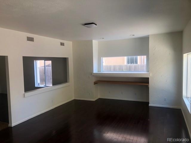 Undisclosed Address Commerce City, CO 80022 - Photo 5 of 12 a living room with a chair and a window