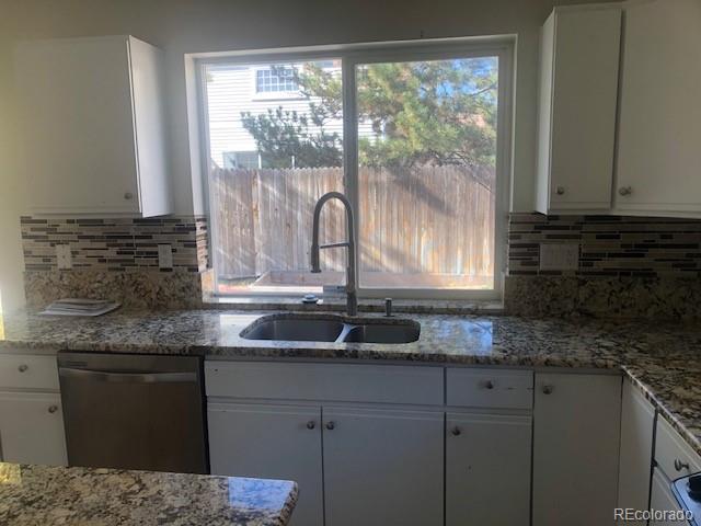 Undisclosed Address Commerce City, CO 80022 - Photo 9 of 12 a kitchen with granite countertop a sink and a window