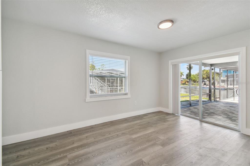 4482 Kingston Drive Hernando Beach, FL 34607 - Photo 13 of 49 an empty room with wooden floor and windows
