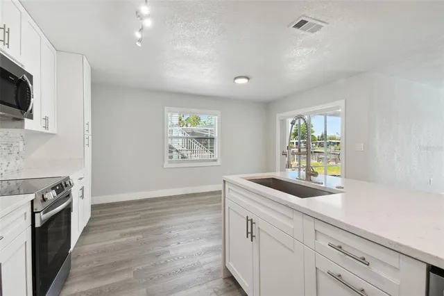 a kitchen with sink and microwave