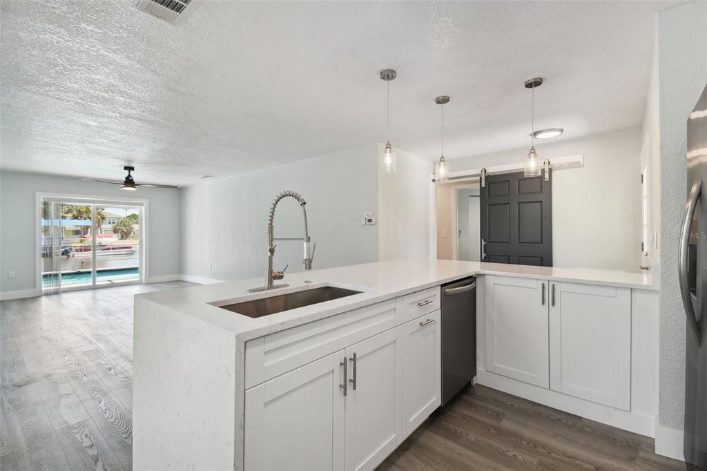 4482 Kingston Drive Hernando Beach, FL 34607 - Photo 16 of 49 a kitchen with a sink and cabinets