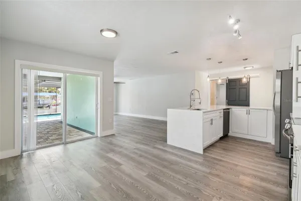 a view of a kitchen with wooden floor and a sink